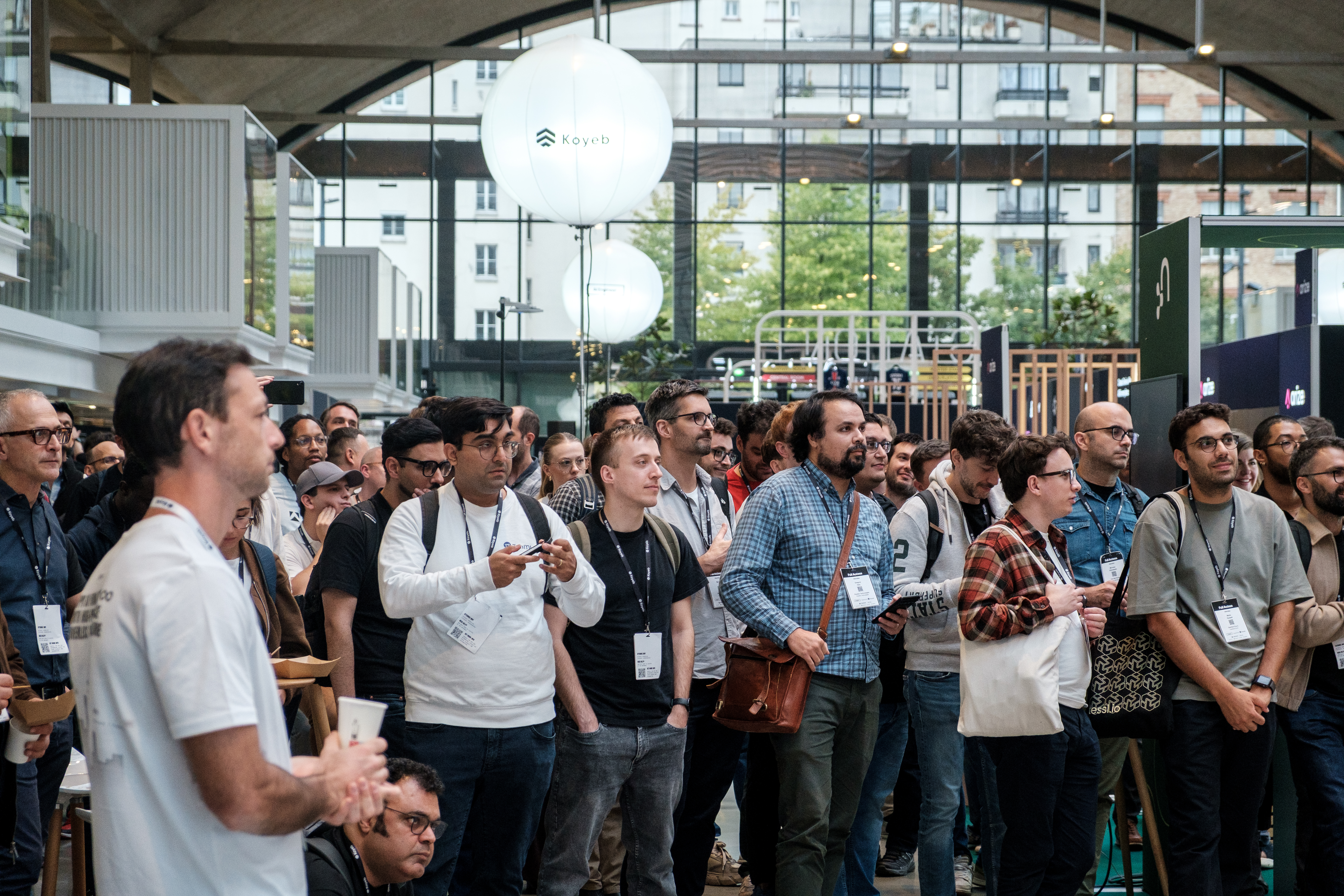 Attendees gather in the expo hall to watch the talks