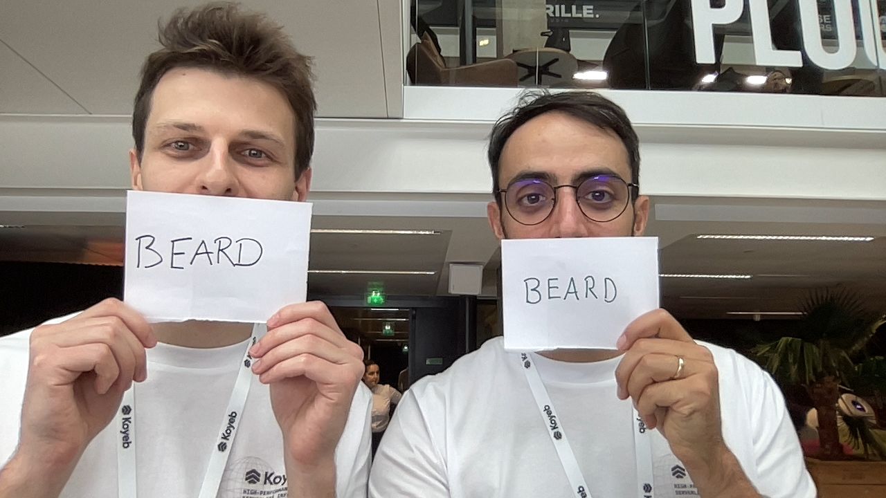 Koyeb engineers holding up papers that say "beard"